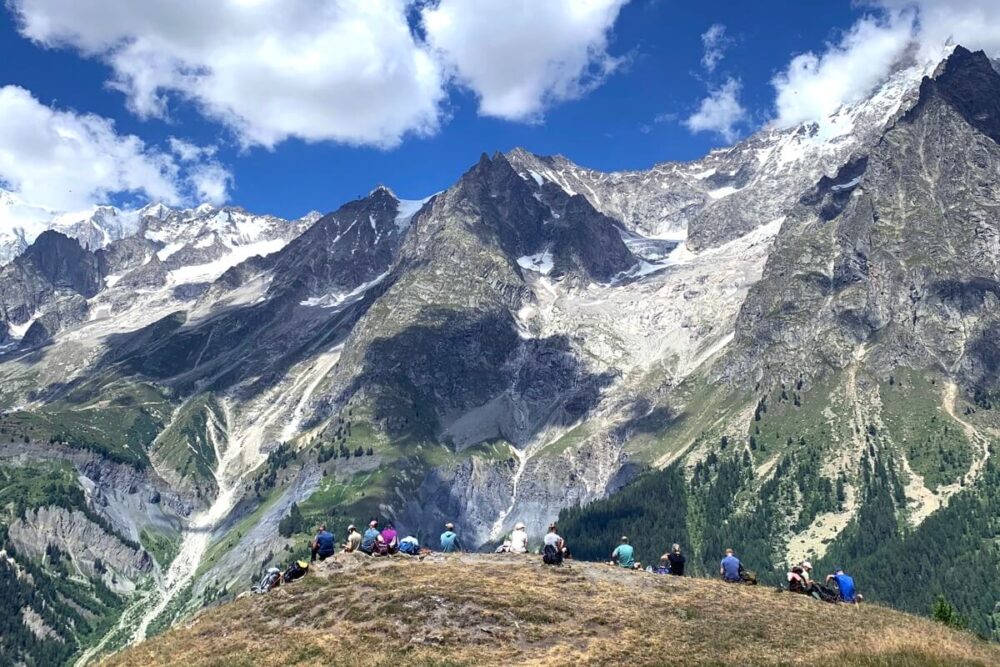 Hikers enjoying lunch overlooking the Aosta Valley, Italy